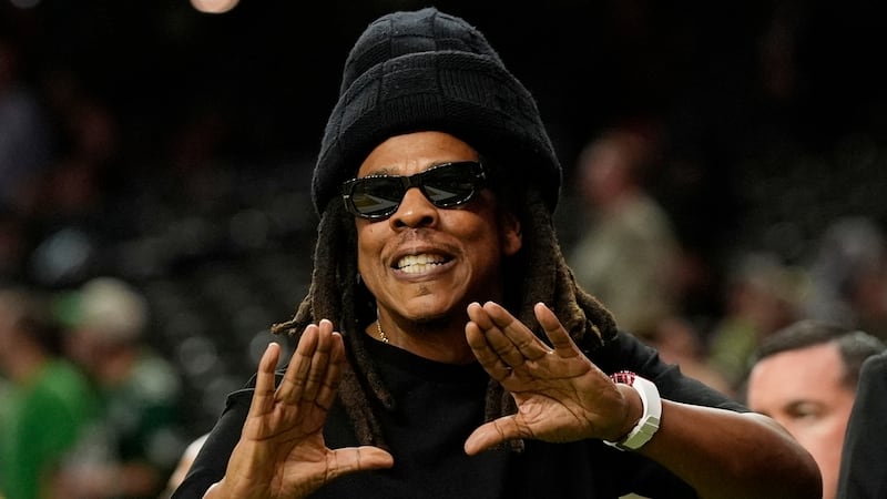 FILE - Jay-Z gestures from the sidelines prior to the NFL Super Bowl 59 football game, Feb. 9,...